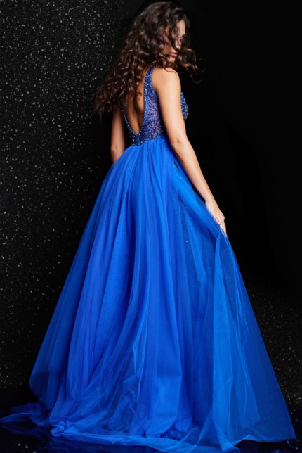 Back view of model wearing Jovani 26058 royal blue dress with scooped back and tulle overlay