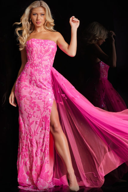 Model wearing Jovani 26134 pink dress with high slit and floral embellishments.