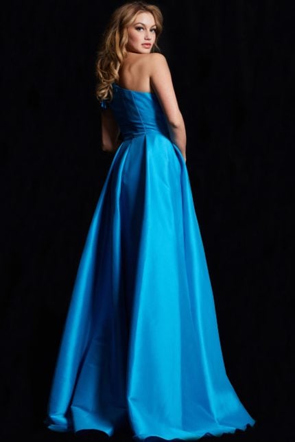 Back view of model in Jovani 26146, a blue gown with an elegant flow.