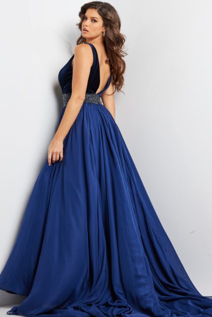 Model wearing 26201 navy gown, back view showcasing flowing silhouette.