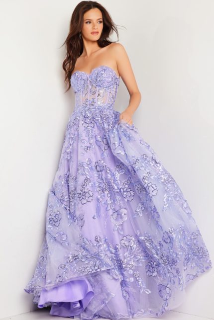 Model in Jovani 26223 lilac gown, showcasing floral appliqué and voluminous skirt.