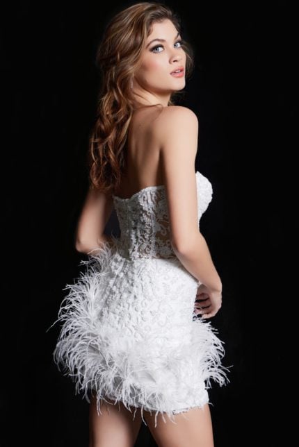 Model wearing Jovani 26226 white dress with feather details, back view.