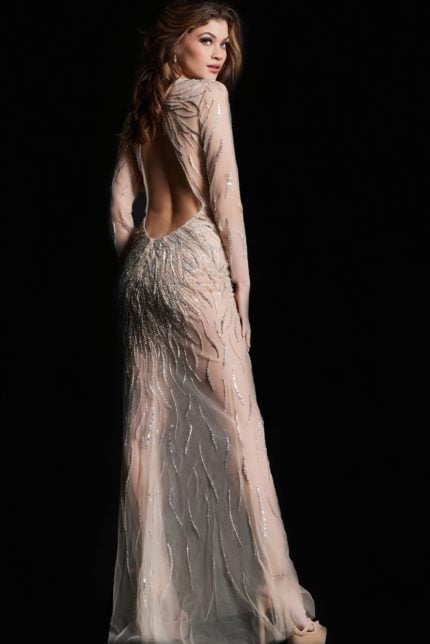 Back view of model wearing Jovani 26275 nude gown with open back and embellishments.