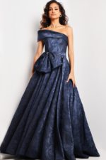 Model wearing Jovani 26281 navy dress with off-the-shoulder neckline and bow detail.