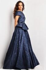 Side view of model in Jovani 26281 navy dress showcasing bow and full skirt.