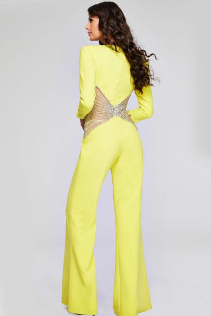 Back view of model in Jovani 26318 yellow jumpsuit showcasing beadwork details.