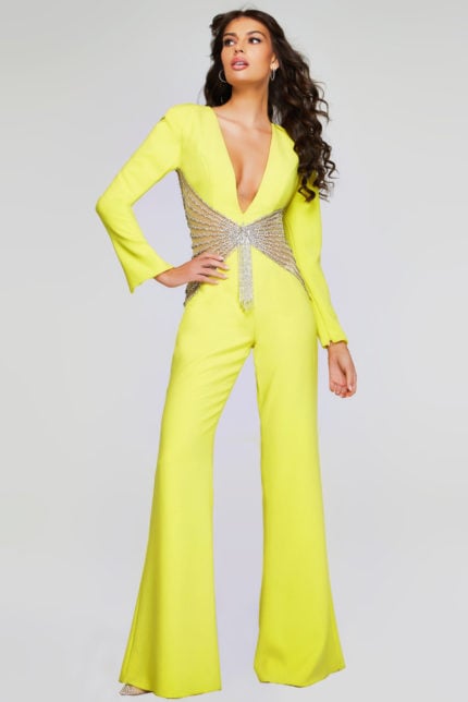 Model wearing Jovani 26318 yellow jumpsuit with V-neckline and beadwork waist.