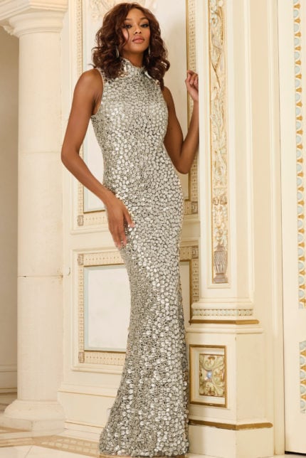 Model wearing Jovani 30054 front view in Nude color, with high neckline and embellishments.