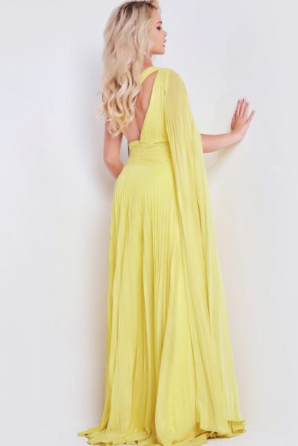 Model wearing Jovani 36462 yellow gown showcasing the back view with pleated design