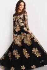 Model in Jovani 36716 black gown, gold floral embroidery, front view.