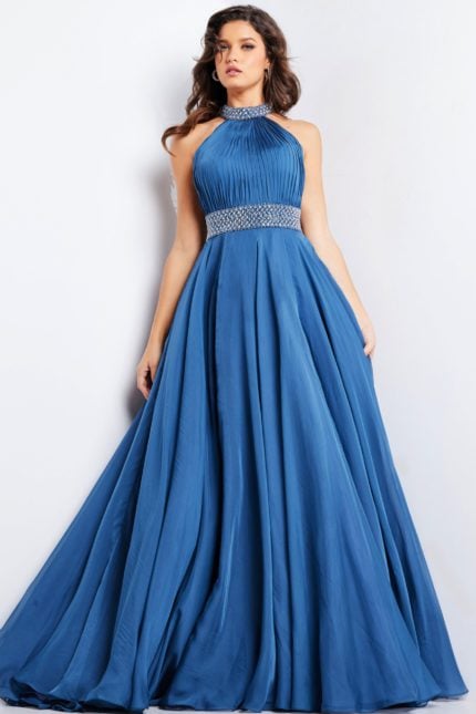 Model wearing Jovani 36749 navy gown with a pleated bodice, beaded waistband, and A-line silhouette.