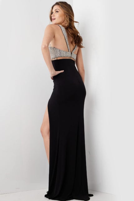 Model showcasing the back of Jovani 36857 black gown with detailed embellishments.