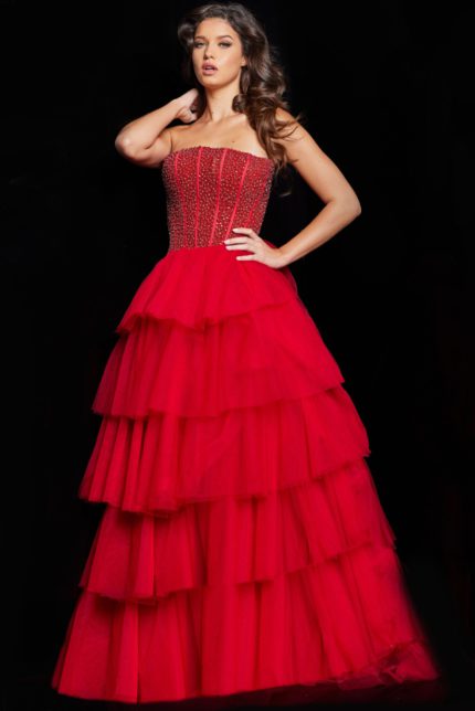 Model wearing Jovani 37210 strapless red gown with tiered tulle skirt, front view.