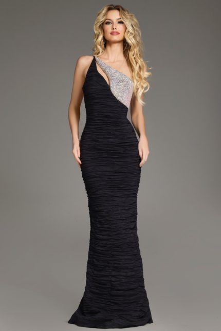 Model wearing Jovani 37267 black mermaid dress with one-shoulder neckline and ruched detailing, front view.