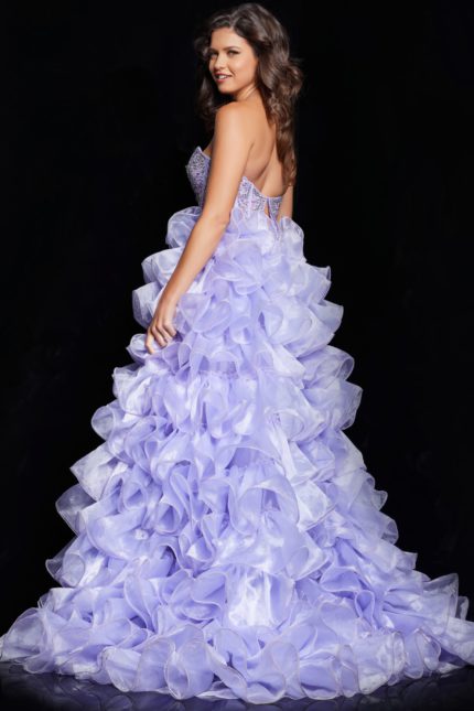 model wearing 37322 lilac dress showing back and ruffled details