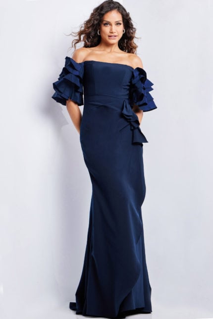 Model wearing Jovani 37674 navy dress with off-the-shoulder ruffle sleeves in mermaid silhouette.