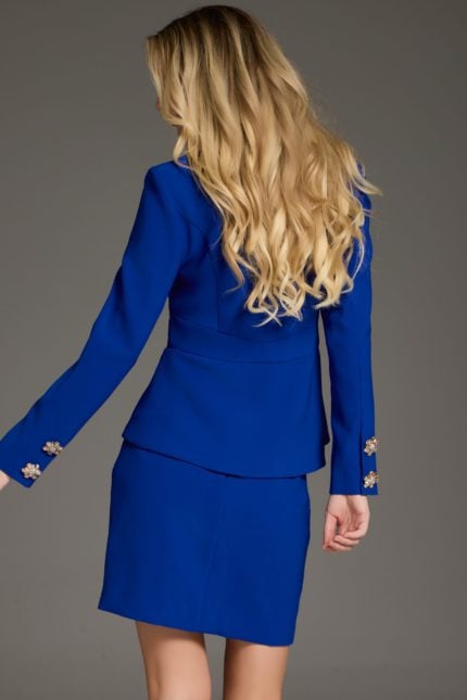 Model wearing 38083 royal blue dress, front view with V-neckline and peplum waist