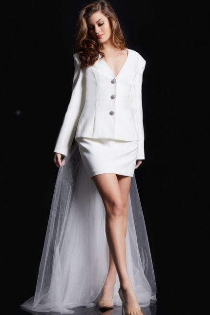 model wearing Jovani 38084 white dress with V-neckline and decorative buttons, front view