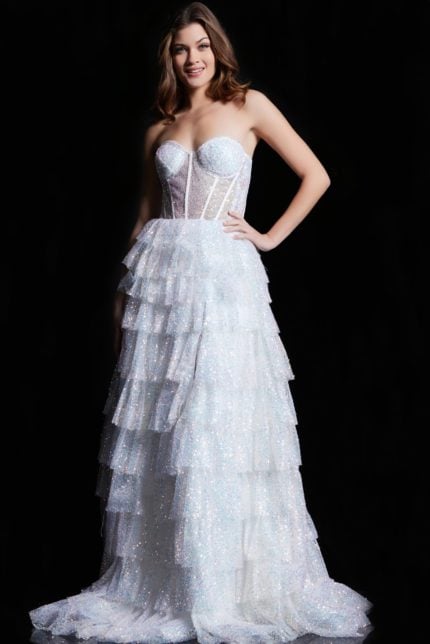 Model wearing Jovani 38165 white dress with tiered ruffles and high slit.