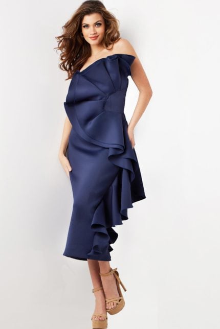 Model wearing Jovani 38187 navy dress, front view, showcasing off-the-shoulder neckline and ruffles.