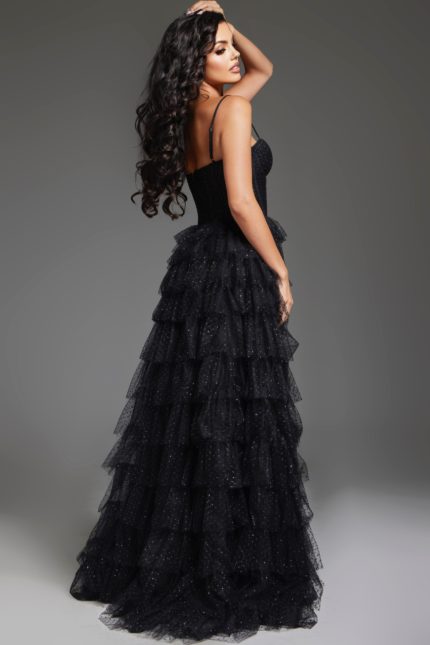 Back view of model wearing Jovani 38278 black evening gown showing tiered ruffle design.