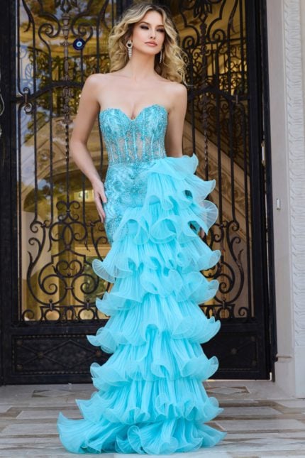 Model wearing Jovani 38295 blue gown with sweetheart neckline and ruffled skirt.