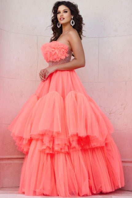 Model wearing Jovani 38299 orange gown with floral ruffles and embellished waist, front full-length view.