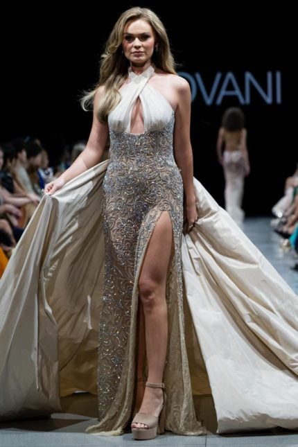 Model wearing Jovani s38442 gown with elegant halter neckline and high slit, embellished with sparkling beading.