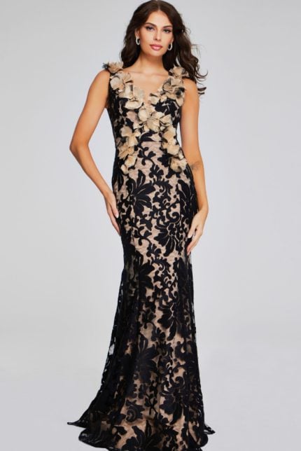 Model wearing Jovani 38497 black lace gown with floral appliqués, front view.