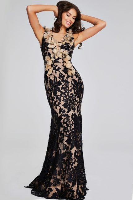 Model wearing Jovani 38497 black lace gown with floral neckline, front view.