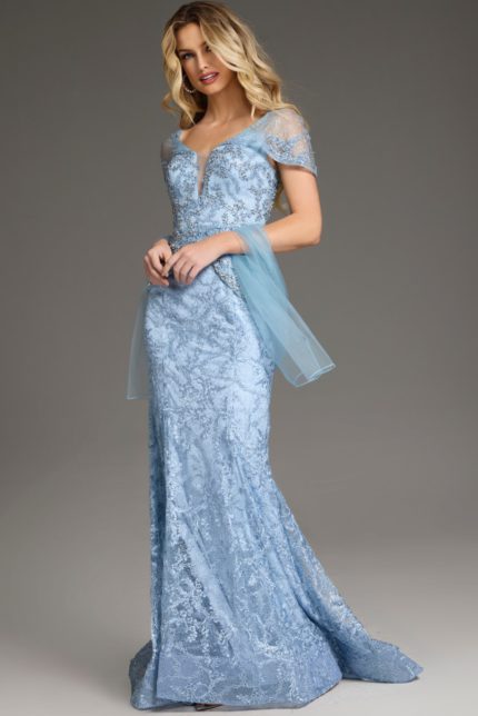 Model wearing Jovani 38514 blue gown with V-neckline and lace detailing, front view.