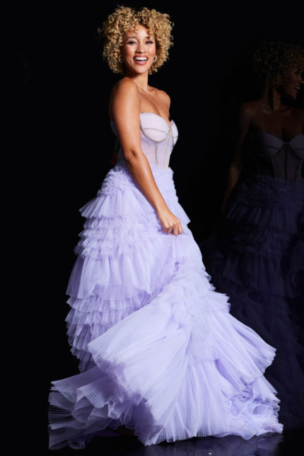 Model wearing Jovani 38539 lilac gown with intricate bodice detail, side view.