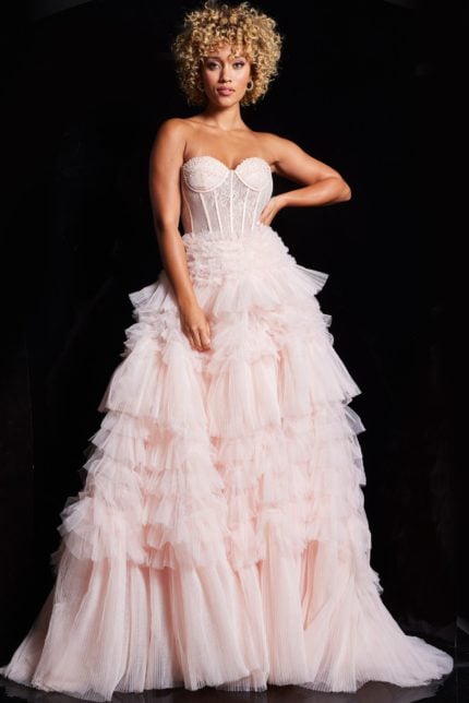 Model wearing Jovani 38540 pink ball gown with sweetheart neckline and ruffled skirt.