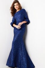 Model wearing Jovani 38791 navy mermaid gown with ruffled sleeves, side glance.