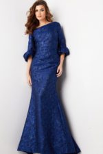 Model wearing Jovani 38791 navy mermaid gown with ruffled sleeves, front view.