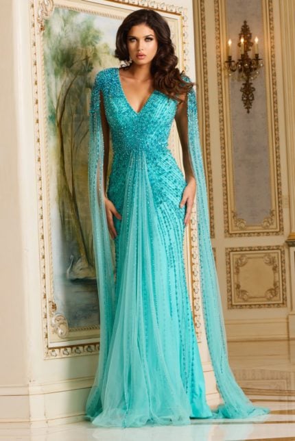 Model wearing Jovani 38964 blue gown with V-neck and beadwork