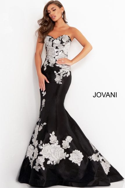 Model wearing Jovani 3917 black gown with silver floral embroidery from the front view.