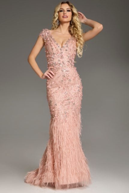 Model wearing Jovani 39174 blush gown with floral embellishments and feathered skirt, front view