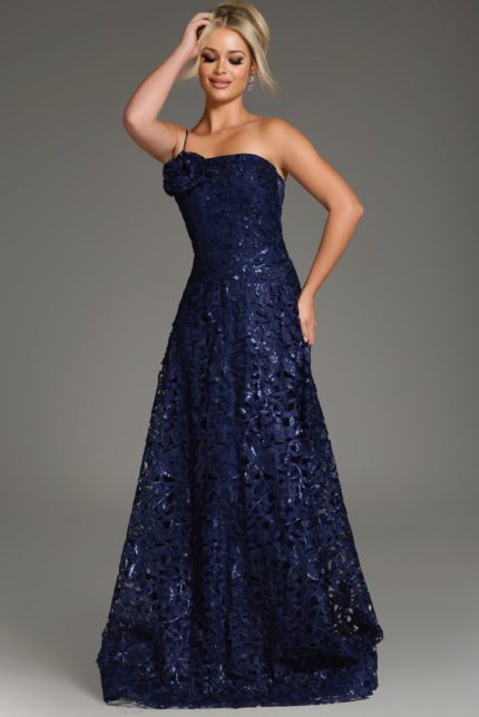 Model wearing Jovani 39224 navy dress with floral lace and one-shoulder neckline, front view.