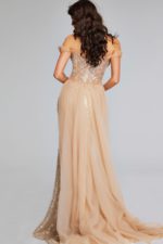 Back view of Jovani 39389 with off-the-shoulder design and flowing sheer skirt.