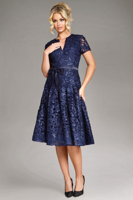 model wearing Jovani 39427 navy dress with hand on waist