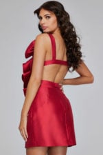 Model wearing Jovani 39639 red dress, back view showing open back design.