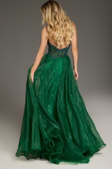 Model wearing Jovani 39650 green dress, back view showing flowing skirt.