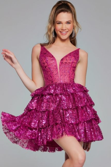 Model wearing Jovani 39700 pink dress with ruffled skirt and deep V-neckline