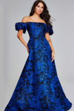 Model wearing Jovani 40315, a royal blue off-the-shoulder gown with puff sleeves.