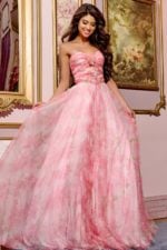 Model wearing Jovani 40402 pink floral A-line gown, twirling.