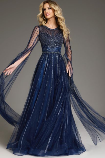 Model wearing Jovani 40629 navy gown with beadwork and long sheer sleeves.