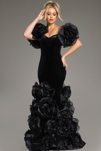 Model wearing Jovani 40843 black velvet gown with dramatic ruffles and sculptural sleeves, front view.