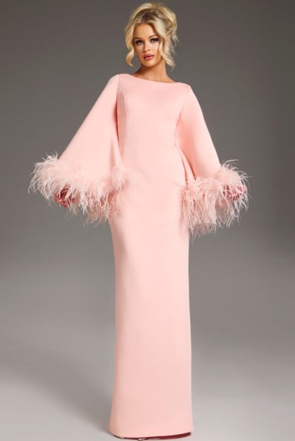 Model wearing Jovani 41077 blush gown with bell sleeves and feather accents from the front.