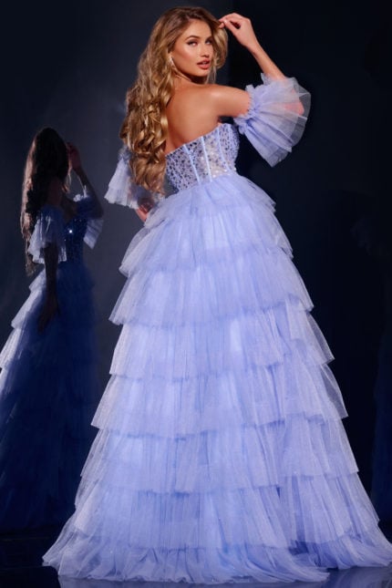 Back view of model wearing Jovani 42249 blue gown with ruffled sleeves and layered tulle.